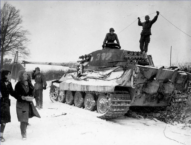 Two American soldiers inspect a destroyed German King Tiger tank, Belgium, 1944.jpg